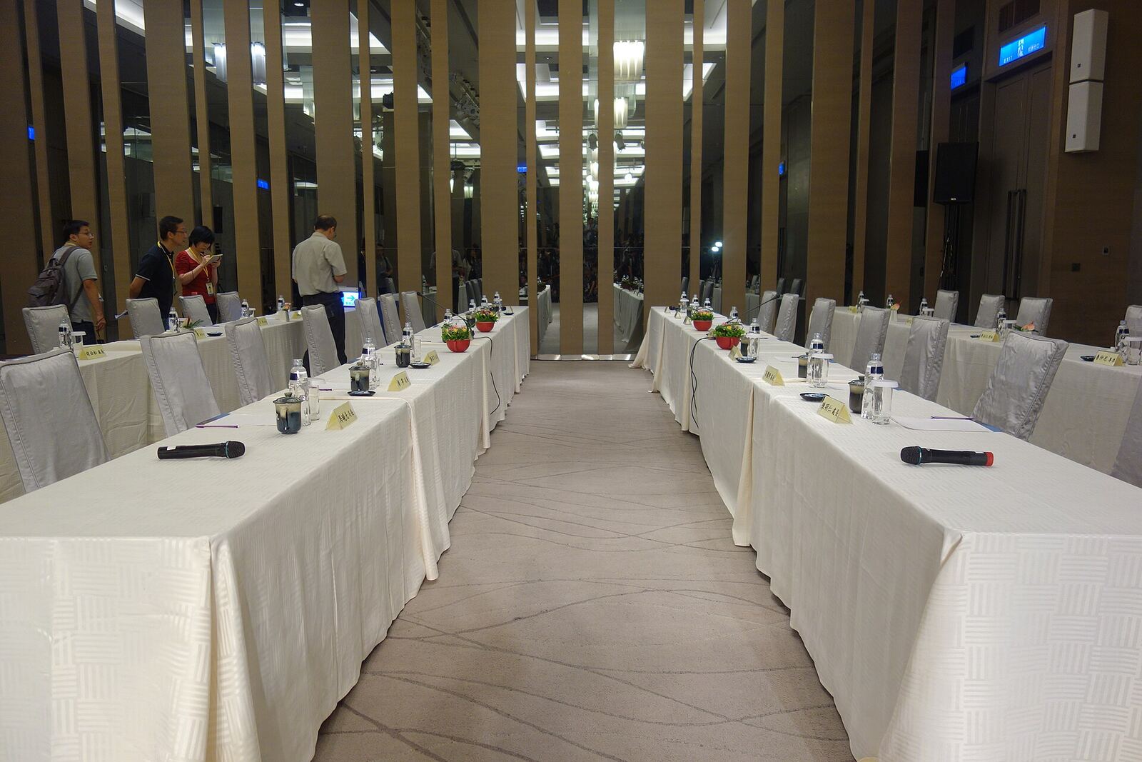 A conference room is prepared for a meeting, illustrating international diplomacy.
