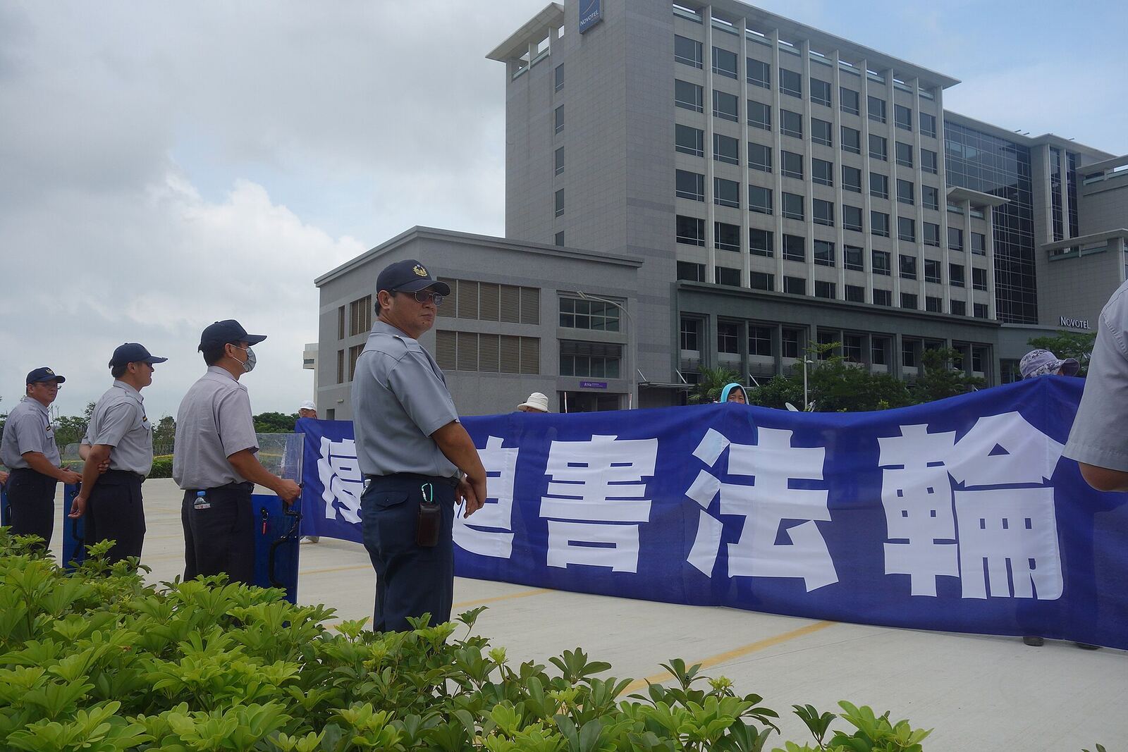 Protestors demonstrate outside a building in Okinawa, highlighting issues of return and sovereignty.
