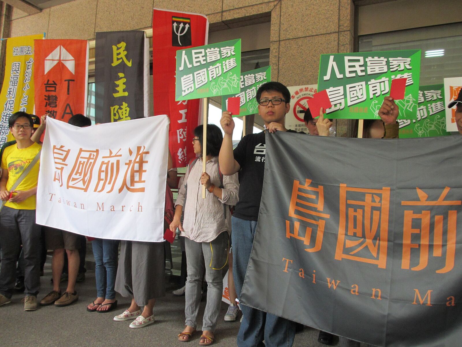 Protesters in Taiwan march with banners advocating for independence and demonstrating their beliefs.