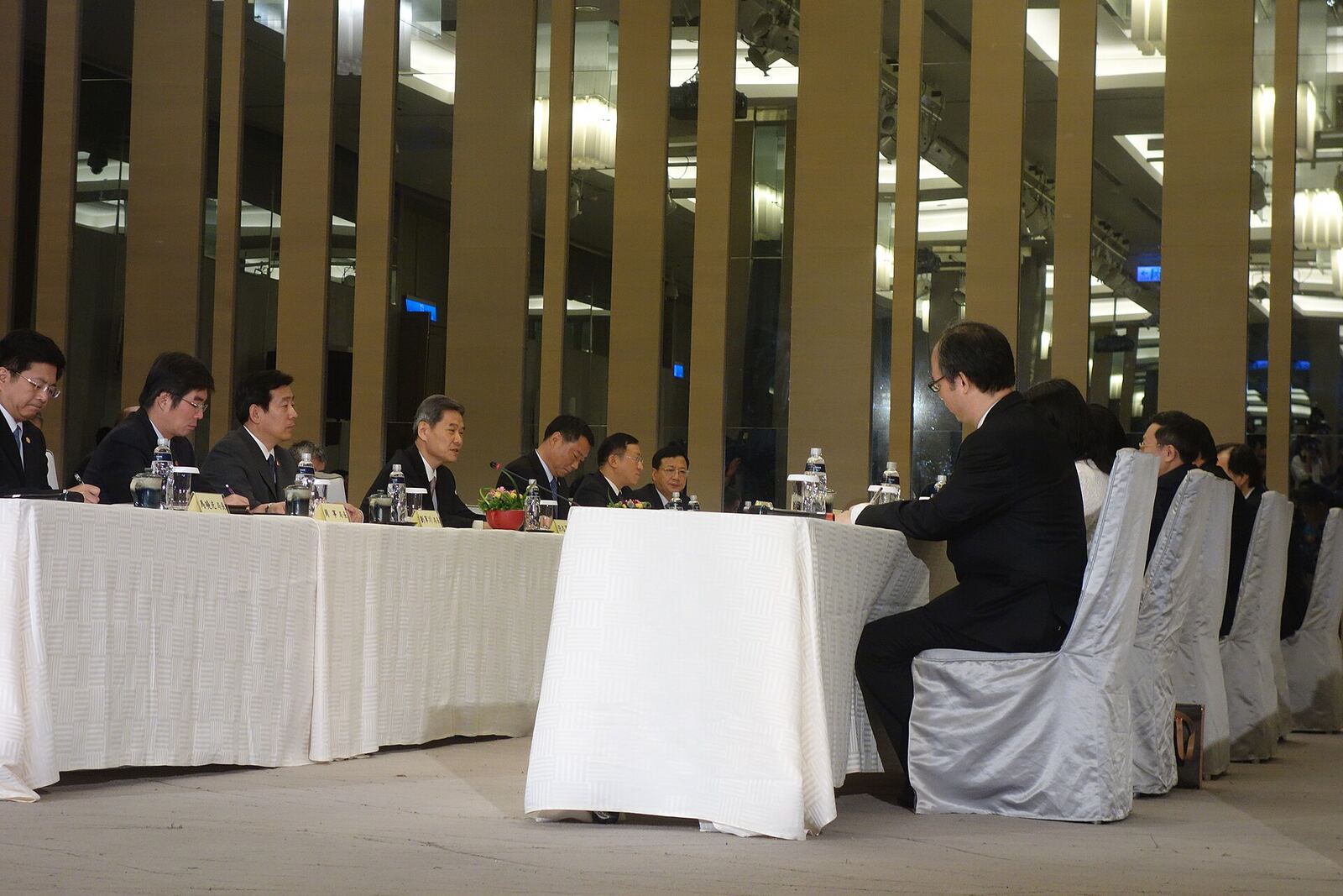 2014 Wang-Zhang Meeting | Some Tact A group of men in suits sit at a long table during the 2014 Wang-Zhang Meeting, illustrating conflict resolution.